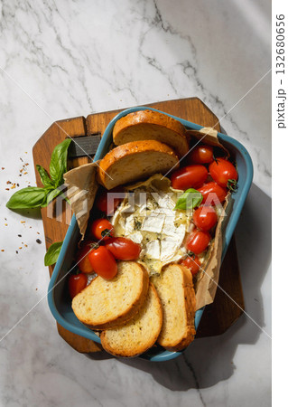 Fresh caprese appetizer with feta, tomatoes, and basil on rustic marble background. Fresh caprese appetizer with feta, tomatoes, and basil on rustic marble background. 132680656