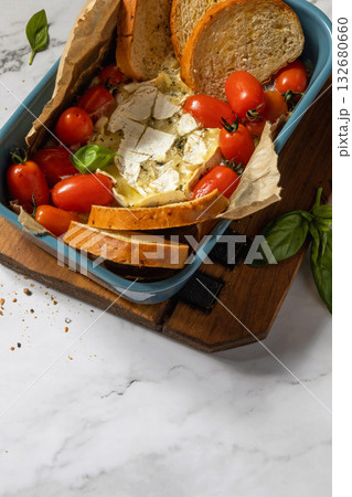 Fresh caprese appetizer with feta, tomatoes, and basil on rustic marble background. Copy space. 132680660
