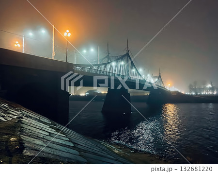 A bridge over a river with lights on it A bridge over a river with lights on it 132681220