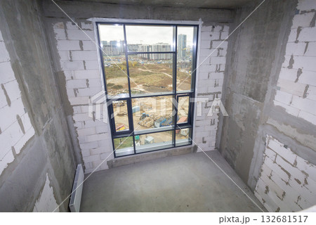 Apartment interior without finishing. Room in new building without repair, walls are not plastered. Apartment interior without finishing. Room in new building without repair, walls are not plastered. 132681517