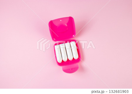 Tampons in pink box. Feminine hygiene products on pastel background. Menstruation and womens health concept. Tampons in pink box. Feminine hygiene products on pastel background. Menstruation and womens health concept. 132681903