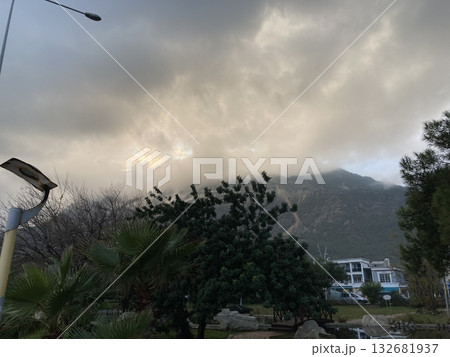 Low fluffy clouds hang over the high mountains, cover their peaks Low fluffy clouds hang over the high mountains, cover their peaks 132681937