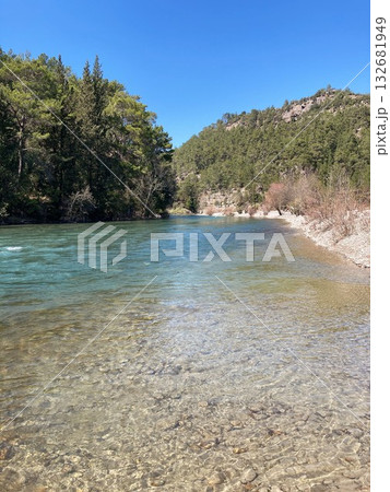 The strong stream of the mountain river comes down from the mountains crystal clear and icy The strong stream of the mountain river comes down from the mountains crystal clear and icy 132681949