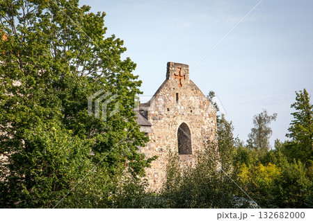Ancient Stone Church Ruins with Cross Surrounded by Green Trees on a Sunny Day Ancient Stone Church Ruins with Cross Surrounded by Green Trees on a Sunny Day 132682000