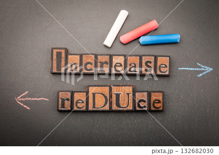 Conceptual contrast between Increase and Reduce written with wooden block letters Conceptual contrast between Increase and Reduce written with wooden block letters 132682030