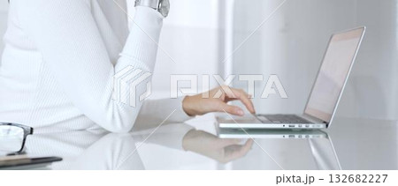 Woman hand typing on laptop keyboard working remotely, female professional thinking during online business meeting. Business people concept Woman hand typing on laptop keyboard working remotely, female professional thinking during online business meeting. Business people concept 132682227