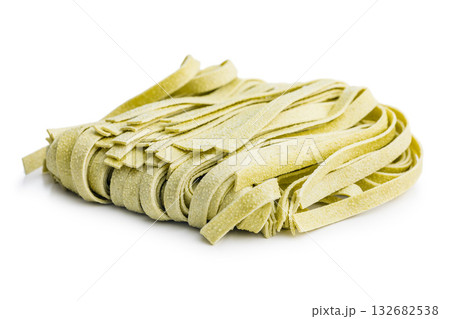 Green tagliatelle pasta isolated on white background. Green tagliatelle pasta isolated on white background. 132682538