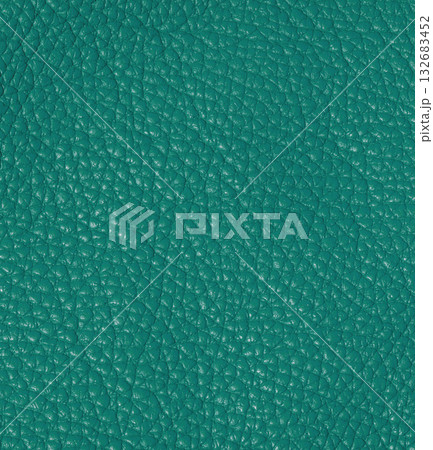 A detailed macro shot of genuine, high-quality leather in a rich turquoise color. The characteristic, slightly glossy texture is visible. 132683452