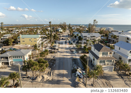 Hurricane aftermath cleanup. Piles of debris on street side in Florida. Garbage from severely damaged homes after storm surge. Consequences of natural disaster 132683480