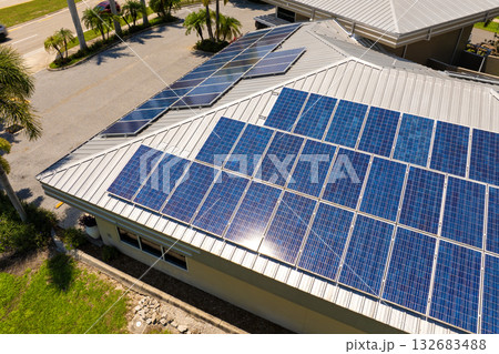 Home roof with blue solar photovoltaic panels for producing clean ecological electric energy. Investing in renewable electricity for retirement income Home roof with blue solar photovoltaic panels for producing clean ecological electric energy. Investing in renewable electricity for retirement income 132683488