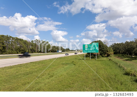 Highway interchange exit sign with direction to North Port and Port Charlotte in Florida. Interstate freeway travel in USA Highway interchange exit sign with direction to North Port and Port Charlotte in Florida. Interstate freeway travel in USA 132683493