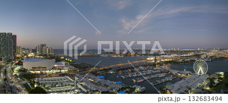 High illuminated skyscrapers of Brickell, city's financial center. Skyviews Miami Observation Wheel at Bayside Marketplace with reflections in Biscayne Bay water and US urban landscape at night 132683494