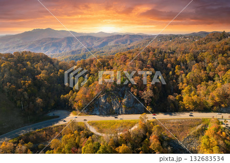 Freeway road with fast moving traffic cars and trucks in North Carolina Appalachian mountains in fall season. Interstate transportation infrastructure in USA Freeway road with fast moving traffic cars and trucks in North Carolina Appalachian mountains in fall season. Interstate transportation infrastructure in USA 132683534