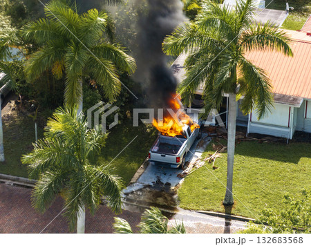 Firefighters extinguishing burning car on residential street in Punta Gorda in Florida Firefighters extinguishing burning car on residential street in Punta Gorda in Florida 132683568