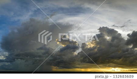 Cumulonimbus clouds forming before thunderstorm on evening sky. Changing stormy cloudscape weather at sunset Cumulonimbus clouds forming before thunderstorm on evening sky. Changing stormy cloudscape weather at sunset 132683689