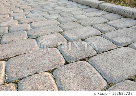 Close-up of slab stone paved path way at park or backyard. Walkway footpath road at house yard garden. Close-up of slab stone paved path way at park or backyard. Walkway footpath road at house yard garden. 132683728