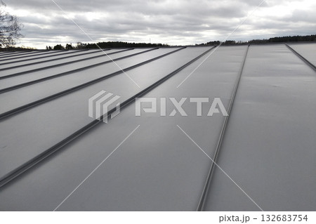 Close-up detail of house roof made from gray metal sheets. 132683754