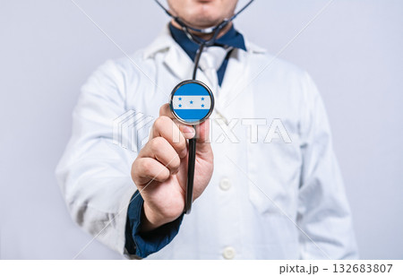 Doctor holding stethoscope with Honduran flag. Honduran health and care concept 132683807