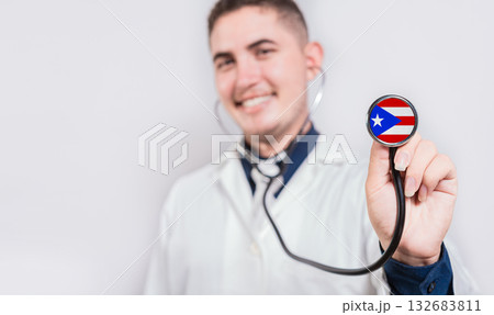 Doctor showing stethoscope with Puerto Rico flag. Puerto Rico national healthcare concept Doctor showing stethoscope with Puerto Rico flag. Puerto Rico national healthcare concept 132683811