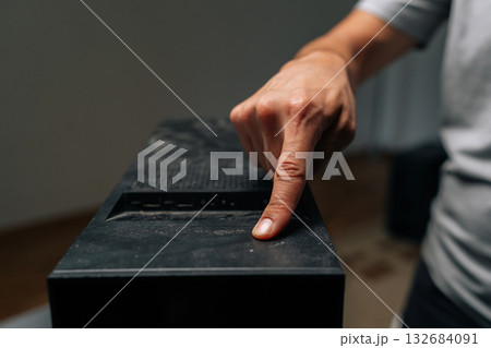 Close-up of technician finger indicating dust buildup on computer case surface, highlighting critical need for systematic electronic device cleaning and preservation. Concept of cleaning computer Close-up of technician finger indicating dust buildup on computer case surface, highlighting critical need for systematic electronic device cleaning and preservation. Concept of cleaning computer 132684091