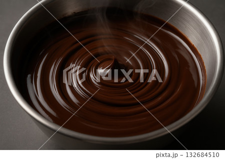 Silky Melted Chocolate Swirl In Metal Bowl With Steam 132684510