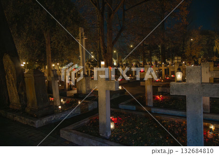 Cemetery at night with candles on graves during All Saints Day 132684810