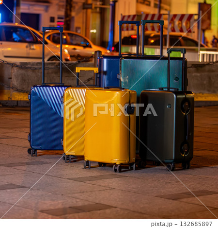 A collection of luggage on a city street. A collection of luggage on a city street. 132685897