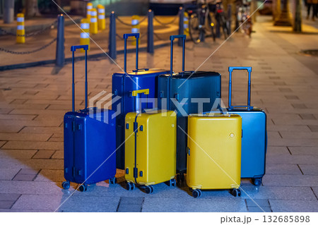 A collection of luggage on a city street. A collection of luggage on a city street. 132685898