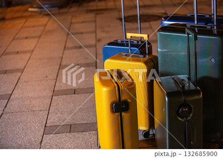 A collection of luggage on a city street. 132685900