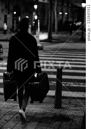 A mysterious traveler with two suitcases. 132685911