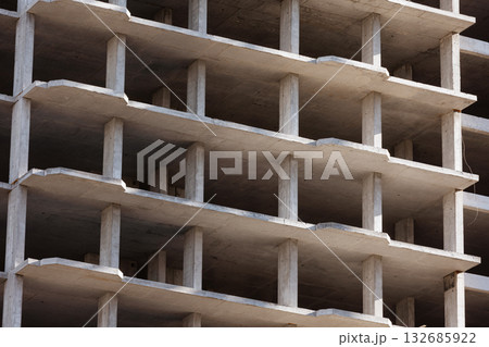 Geometric concrete structure of a building under construction. 132685922