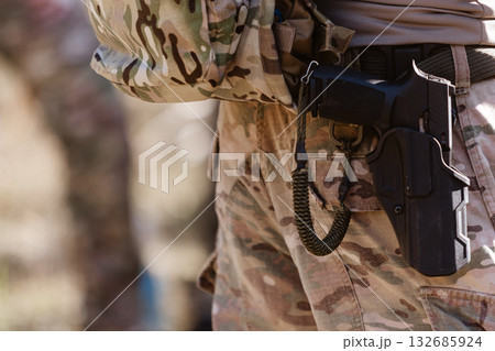 A soldier's pistol in a tactical holster. 132685924