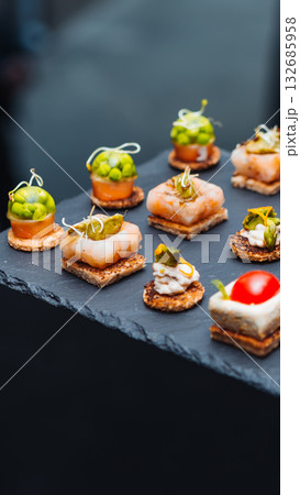 Elegant gourmet appetizers on a slate tray. 132685958