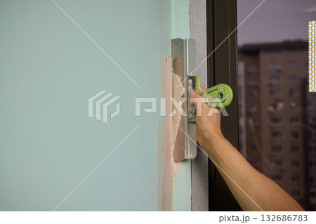 The Wall Repair Process Involves Properly Using Spackling Paste for a Quality Finish 132686783