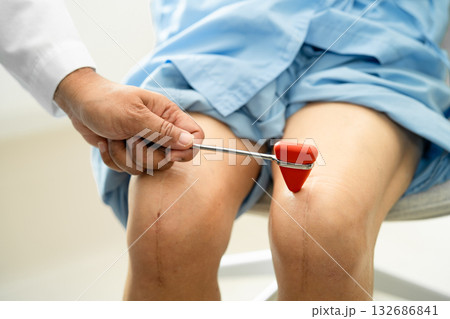 Asian doctor physiotherapist examining, massaging and treatment knee and leg of senior patient in orthopedist medical clinic nurse hospital. 132686841
