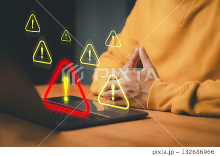 Person use a laptop computer with caution warning sign for notification error. Cybersecurity technology concept of computer virus detect, network security and maintenance, personal data protection. Person use a laptop computer with caution warning sign for notification error. Cybersecurity technology concept of computer virus detect, network security and maintenance, personal data protection. 132686966
