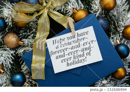 Greeting card with HOPE YOU HAVE A REMEMBER FOREVER AND EVER KIND OF HOLIDAY text on handmade Christmas wreath. Festive mood new year celebration. Postcard decoration decor 132686994