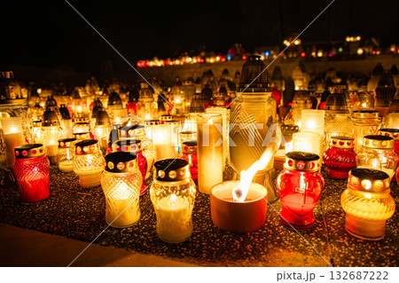 All Saints Day candles and lanterns glowing at night, cemetery memorial background in Poland 132687222