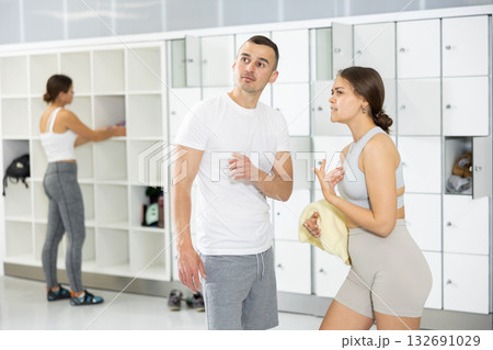 Young man and woman talking in locker room Young man and woman talking in locker room 132691029