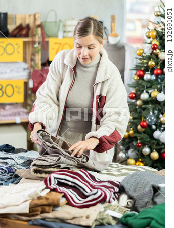 Adult woman choosing trousers in clothing store 132691051