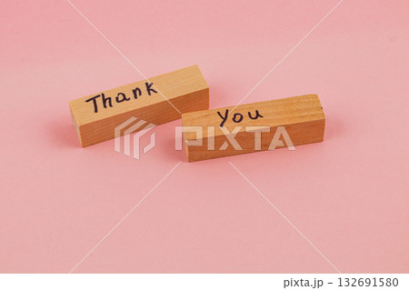 Wooden blocks with thank you message on pink background Wooden blocks with thank you message on pink background 132691580