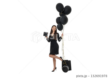 Woman in black dress holding balloons and shopping bags, isolated, PNG 132691978