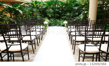 Long white carpet leads to a row of black chairs Long white carpet leads to a row of black chairs 132692368