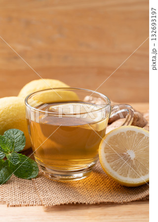 Lemon and ginger tea in cup glass with mint leaf, Healthy hot drink 132693197
