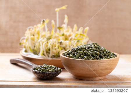 Mung bean seeds and sprouts on wooden background, Food ingredient in Asian cuisine Mung bean seeds and sprouts on wooden background, Food ingredient in Asian cuisine 132693207