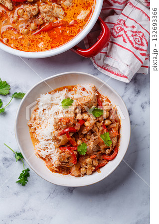 Tikka masala with chicken, chickpeas and rice in bowl. 132693366