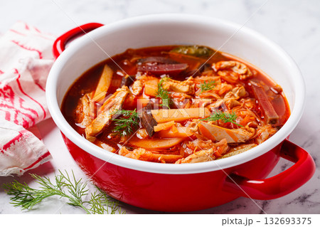 Classic borscht with chicken in a red pot. Classic borscht with chicken in a red pot. 132693375