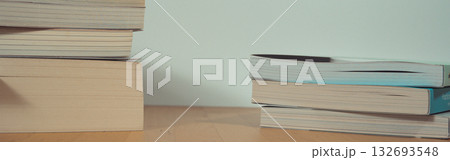stack of book on table with soft focus library or bookstore background 132693548