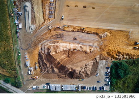 Aerial view of construction site with heavy machinery and workers Aerial view of construction site with heavy machinery and workers 132693960