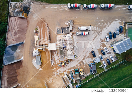 Aerial view of concrete production plant with mixer trucks and silos Aerial view of concrete production plant with mixer trucks and silos 132693964